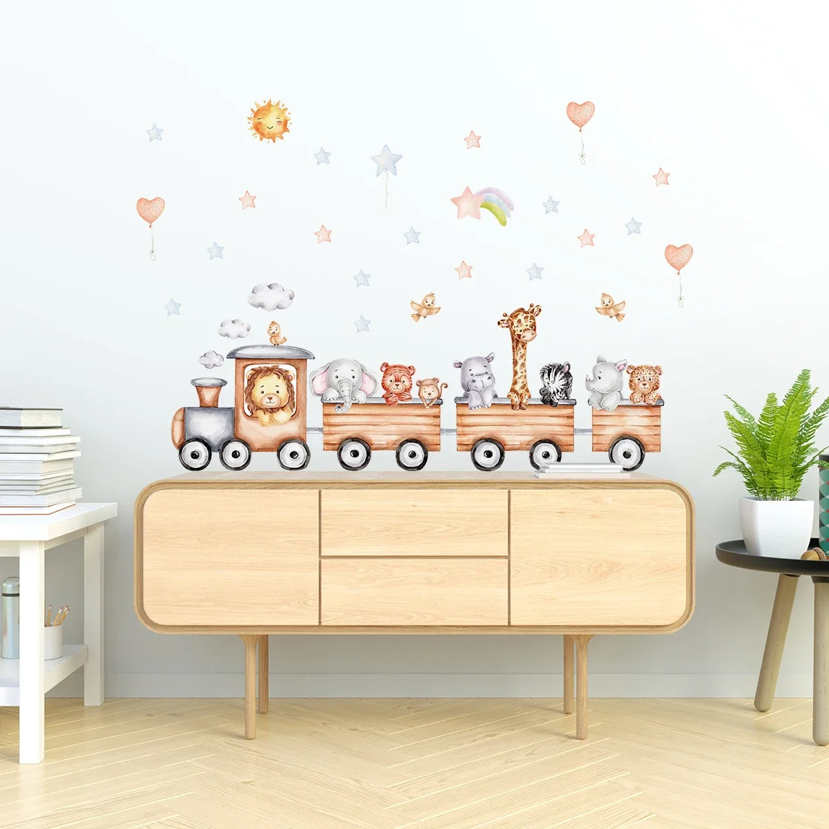 Déco Chambre Bébé Murale et Adhésive au Design de Train sur un mur avec une commode dessous