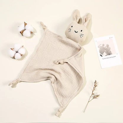 Doudou Animal Lapin Doux et Durable sur fond beige avec une photo et des morceaux de coton