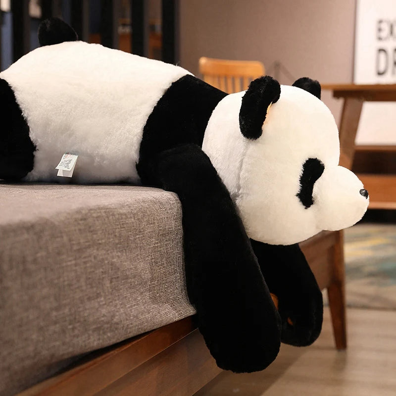 Doudou Géant Plaisant en Forme de Panda sur un canapé avec une table et une chaise en bois en fond